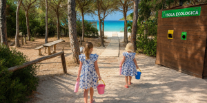 Family walking a boardwalk to the beach, enjoying sustainable travel with BeachSupplies